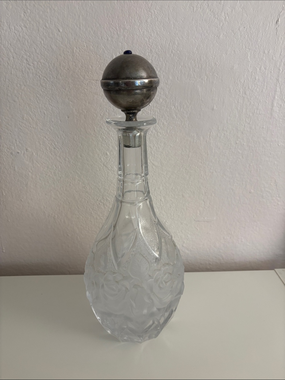 Vintage glass decanter with a silver-plated lid